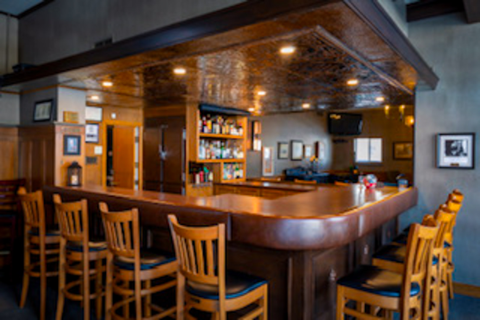 The bar at The Brantford Club under its pressed-copper ceiling